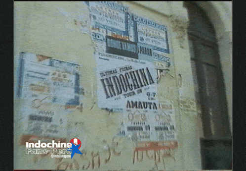 a wall covered in posters including one for indochina