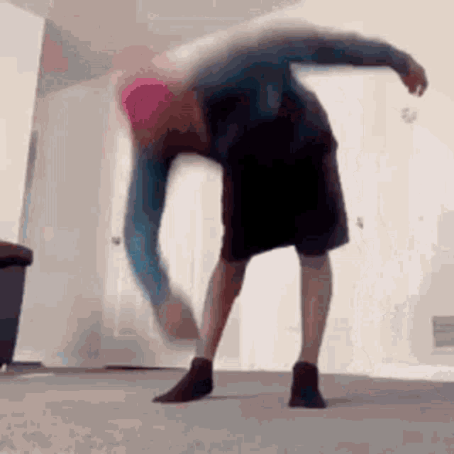 a person is doing a handstand in a living room .