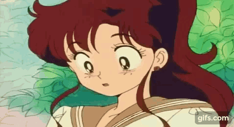 a close up of a cartoon girl with red hair and earrings .