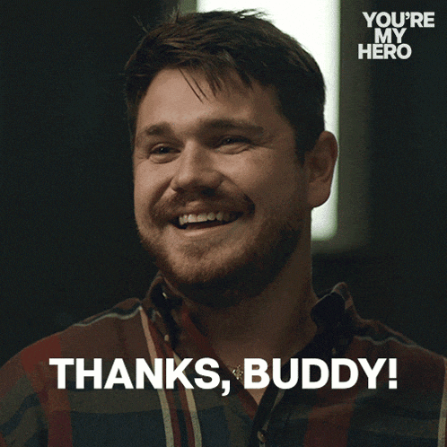a man in a plaid shirt is smiling and says " thanks buddy "