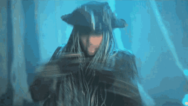 a man with dreadlocks and a pirate hat