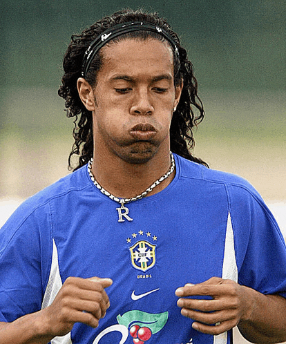 a man wearing a blue shirt that says ' brasil ' on it