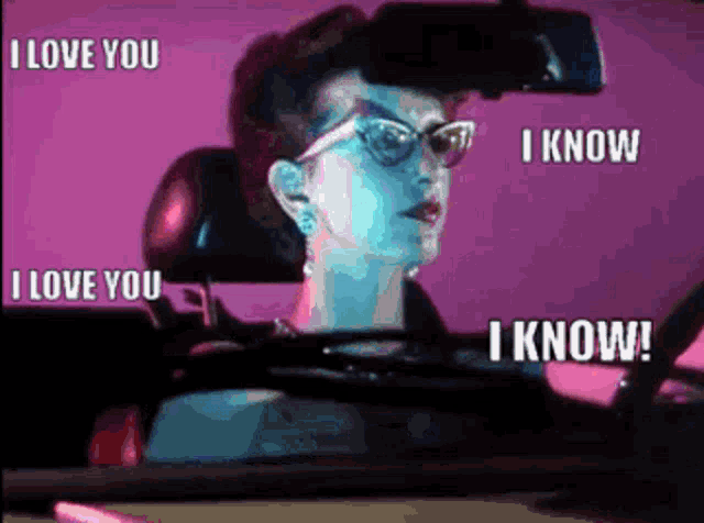 a woman wearing glasses is driving a car and says i love you i know and i know