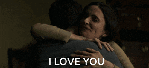 a woman hugging a man with the words " i love you " above them