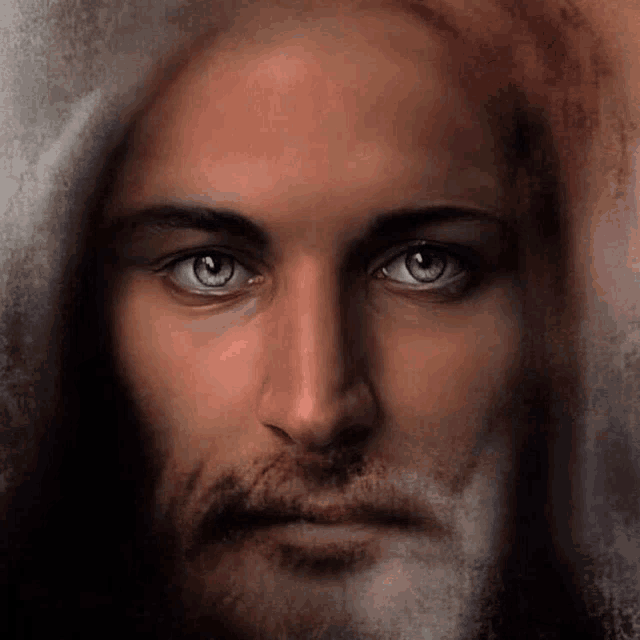 a close up of jesus ' face with blue eyes and a beard