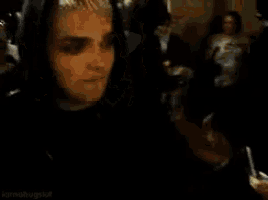 a close up of a person wearing a hoodie in a crowd .
