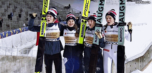 a group of young skiers holding their skis with the word namm on them