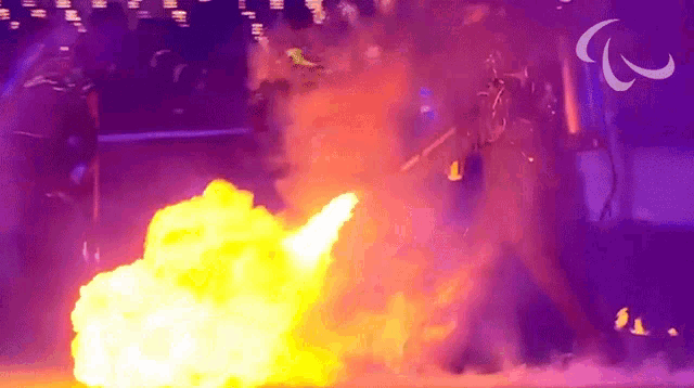 a purple background with a paralympic logo and a fire coming out of it