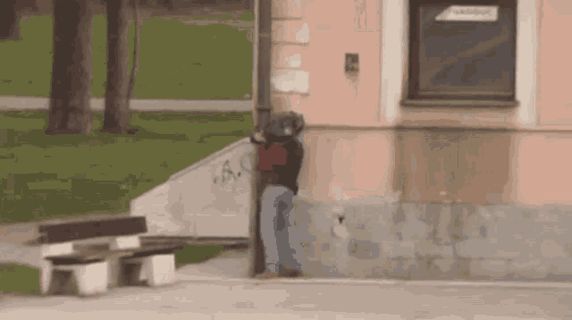 a person standing on the side of a building with graffiti on the wall that says a.s.
