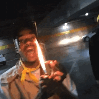 a man is holding a lighter with a flame on it .