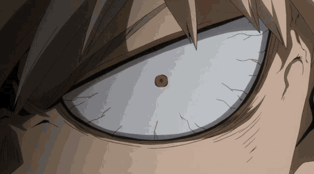 a close up of a person 's eye with a red spot