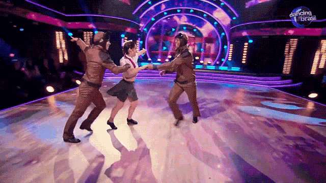 a group of people are dancing on a stage with a sign that says dancing brasil on it