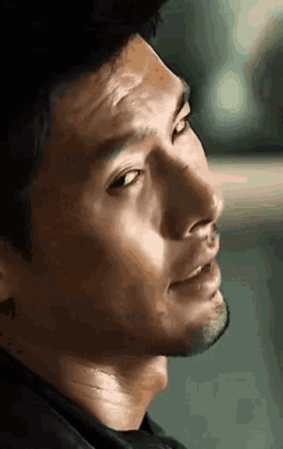 a close up of a man 's face looking to the side