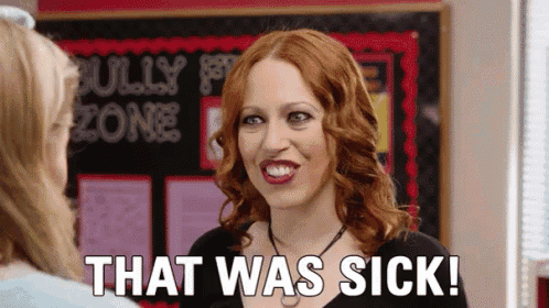 a woman with red hair is talking to another woman in front of a bulletin board and says `` that was sick ! ''