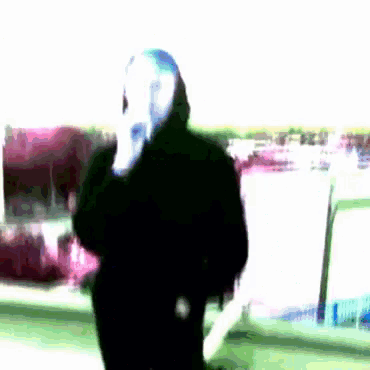a blurry picture of a person wearing a white mask