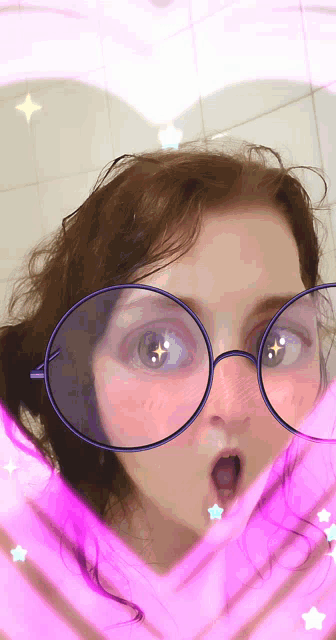 a girl wearing glasses with a heart shaped frame around her