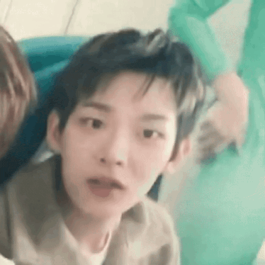 a close up of a person making a funny face while sitting in a chair .