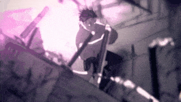 a man is sitting on a ledge holding a sword and looking down .