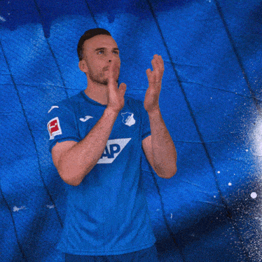 a man wearing a blue shirt with sap on it