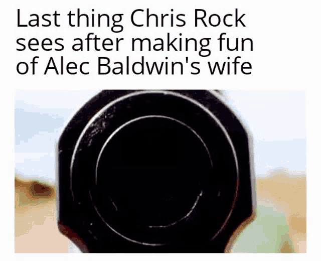 a close up of a gun with the words last thing chris rock sees after making fun of alec baldwin 's wife below it