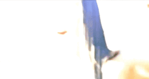 a close up of a woman 's face with a man in the background