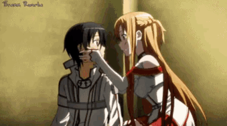 a girl is touching a boy 's face in a sword art online anime .