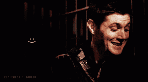 a man is smiling with a smiley face on his back