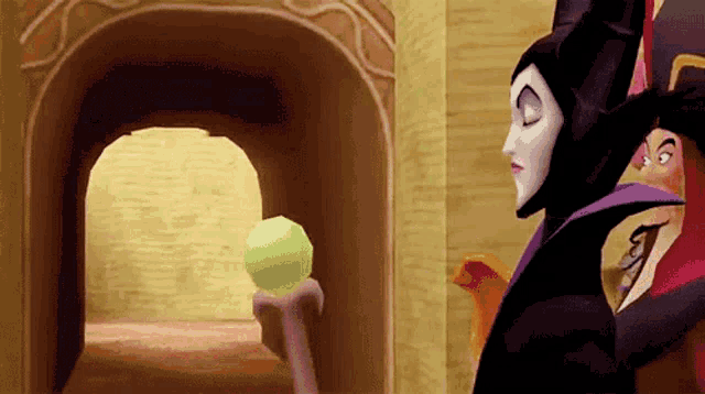 a cartoon of maleficent looking at a green ball in a tunnel