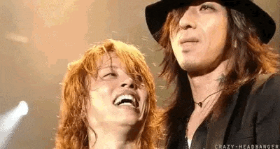 a man and a woman are standing next to each other on a stage .