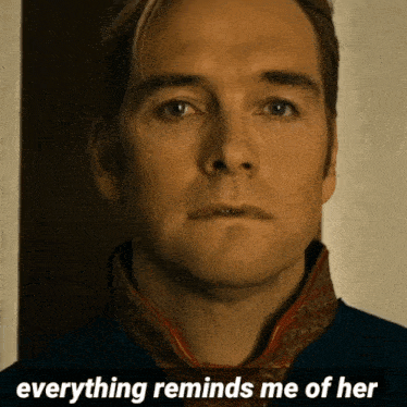 a close up of a man 's face with the words " everything reminds me of her " below him