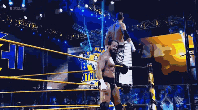 two wrestlers are in a wrestling ring with a sign that says # 2019cw4