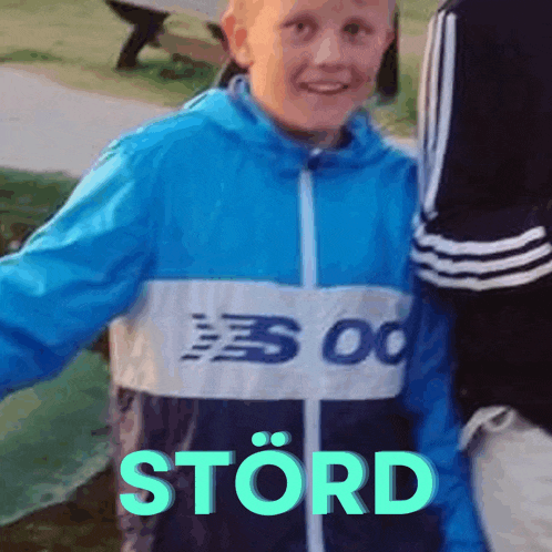 a boy wearing a blue jacket with the word stord written on it