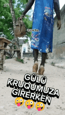 a woman in a blue dress and heels is walking down a dirt road