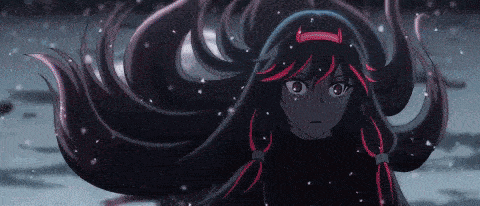 a girl with long black hair is standing in the snow and looking at the camera .