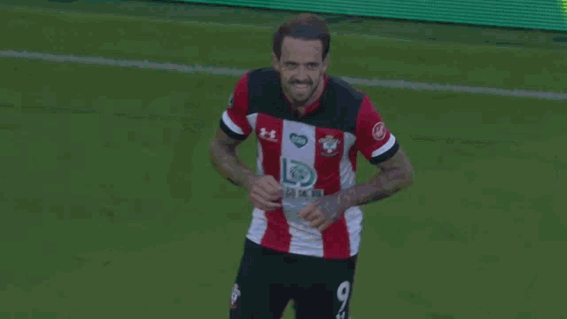 a soccer player with the number 16 on his back is hugging another player