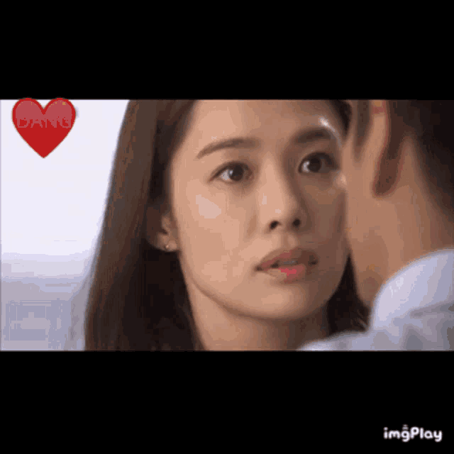 a man and a woman are looking at each other with a heart in the background that says dang