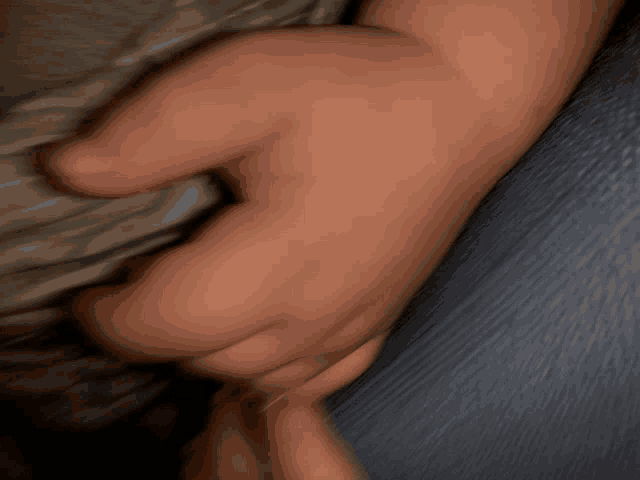 a blurred image of a person 's hand with the thumb pointing up
