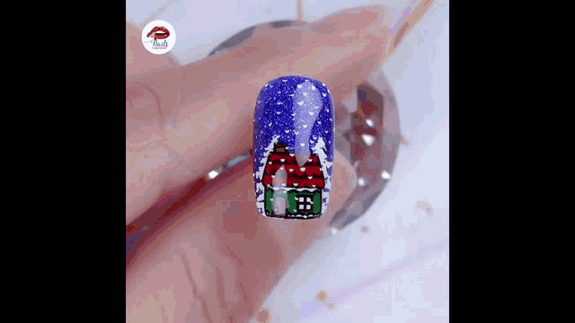 a close up of a person 's nails with a christmas design on them