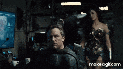 a woman in a wonder woman costume is standing next to a man