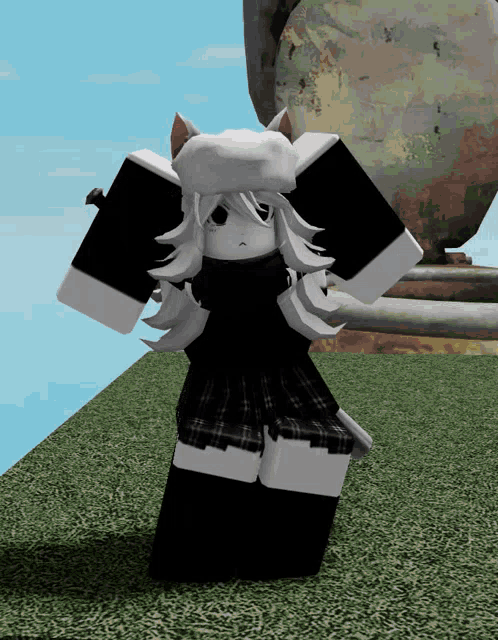 a girl in a black and white outfit is standing in a field