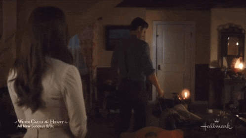 a hallmark ad for when calls the heart shows a man and woman in a living room