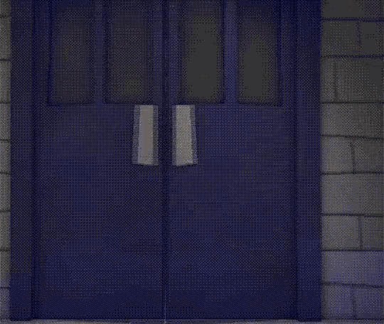 a cartoon character is standing in a doorway in a dark room .