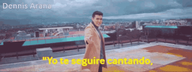a man in a tan coat is standing on a rooftop with the words yo te seguire cantando below him