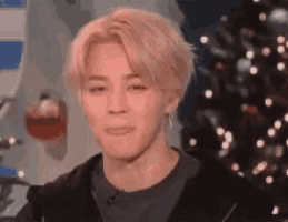 a close up of a person with blonde hair making a funny face .
