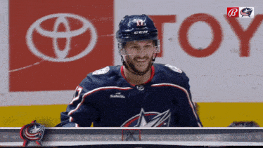 a hockey player in front of a toyota ad