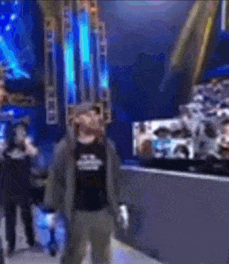 a blurry picture of a man in a black shirt that says ' a ' on it