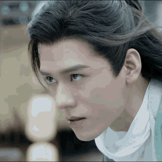 a close up of a man with long hair