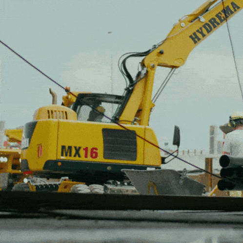 a yellow excavator with the numbers mx16 on it