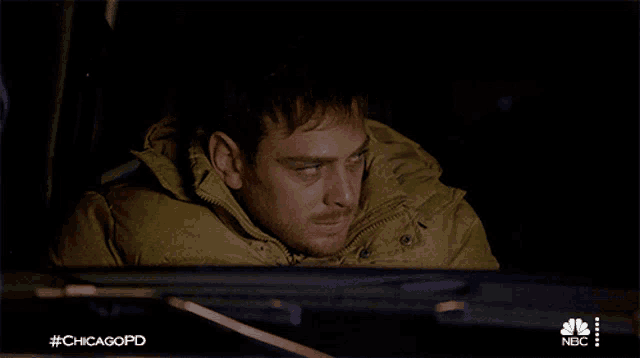a man sitting in a car with #chicagopd on the bottom right