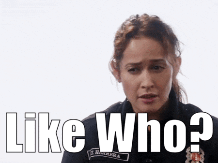 a woman in a police uniform is asking " like who ? "
